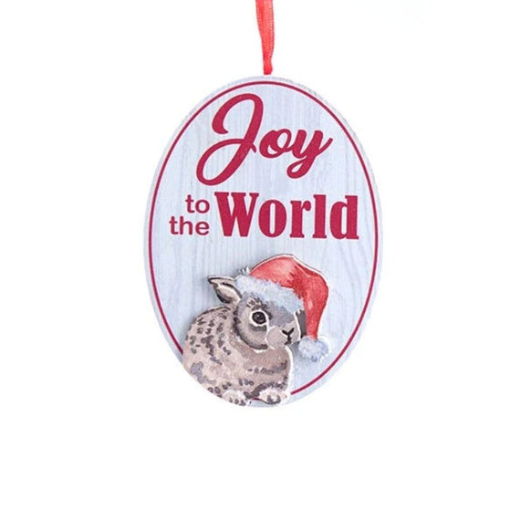 Oval ornament with the words “Joy to the World” and an illustrated bunny wearing a Santa hat on a white wood-look background.