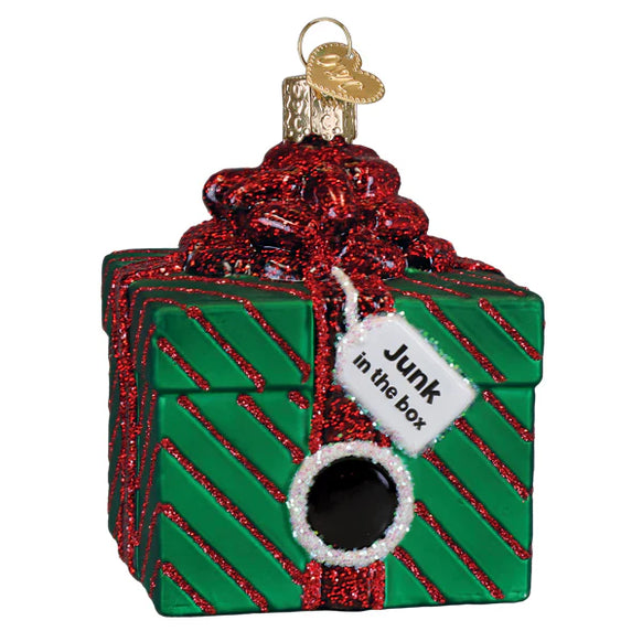Decorative ornament shaped like a green box with a red bow and 'Junk in the box' tag on a white background