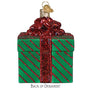 Green gift box ornament with red ribbon on a white background