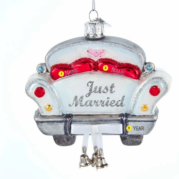 Personalized Just Married car with bells ornament featuring a white getaway car, red seats, silver glitter accents, dangling bells, and hanging loop.
