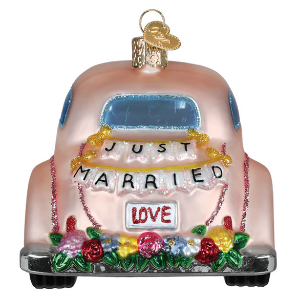 Decorative ornament shaped like a pink car with 'Just Married' and 'Love' text on a white background.
