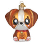 Glass ornament of a Kawaii brown and white dog with a red collar on a white background
