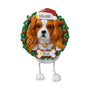 Personalized Cavalier King Charles Spaniel ornament with a brown and white dog in a Santa hat framed by a green wreath with space for a name and year.