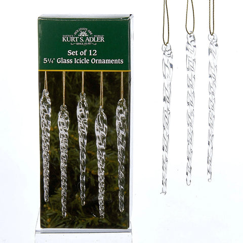 Boxed set of 12 clear glass icicle ornaments, shown in a green package beside three hanging twisted icicle ornaments with gold hanging cords.