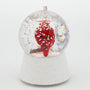 Back view of cardinal waterglobe ornament showing a red cardinal inside a clear glitter-filled globe on a white glittered base.
