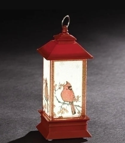 Red LED lantern ornament with cardinal artwork on the panels, gold trim, and a classic lantern shape.