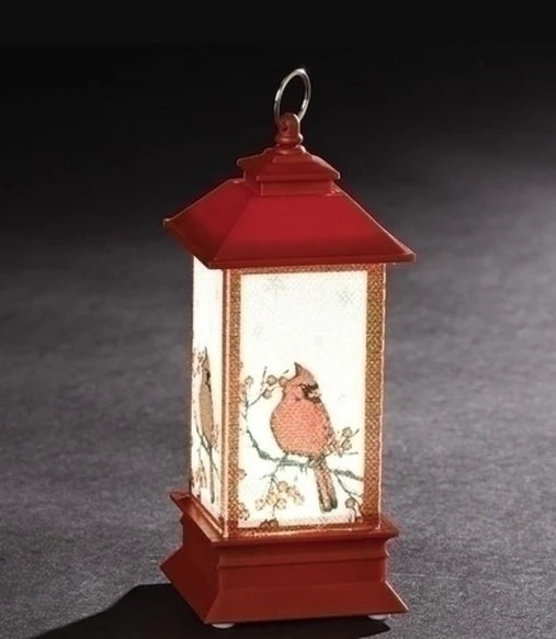 Red LED lantern ornament with cardinal artwork on the panels, gold trim, and a classic lantern shape.