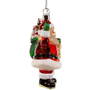 Side view of a lighted glass Santa ornament showing Santa’s red suit, green mitten, white glitter trim, and gift bag behind him.