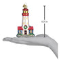 Decorative lighthouse ornament on a hand with measurement label