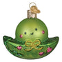 Green glass ornament shaped like a peapod with a face on a white background