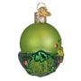 Green glass ornament shaped like a peapod with a face on a white background side view