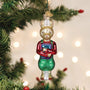 Decorative Christmas ornament of a rabbit figure with a book, hanging on a tree with lights in the background.