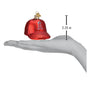 Glass ornament shaped like a red baseball cap with an A's logo, held in a hand to show size.