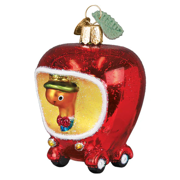 Decorative ornament shaped like a red apple with a small figure inside on a white background