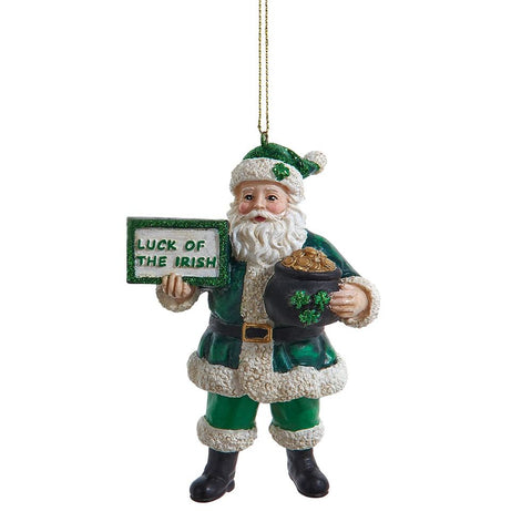 Santa ornament dressed in green with a glittered hat, holding a gift and mug, accented with shamrock details.