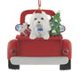 Decorative Christmas ornament of a Maltese dog in a red truck with a tree and gift.