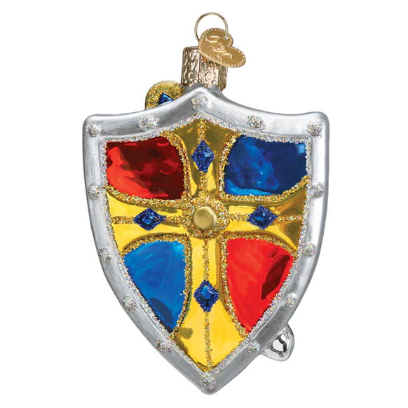 Decorative glass shield ornament with red, blue, and gold colors on a white background
