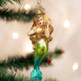 Mermaid ornament hanging on a Christmas tree with blurred lights in the background