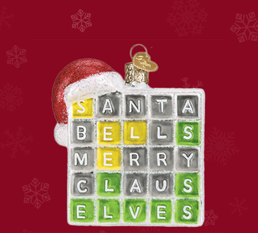 Glass Old World Christmas Merry Words Ornament that looks like a Wordle 5-letter puzzle game with a Santa hat on left corner