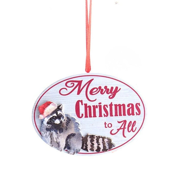 Oval ornament with the words “Merry Christmas to All” and an illustrated raccoon wearing a Santa hat on a white wood-look background.