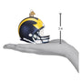 Navy and yellow Michigan football helmet ornament with a hand for scale on a white background