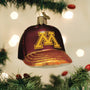 Decorative ornament shaped like a baseball cap with a Minnesota gophers logo, hanging on a Christmas tree.