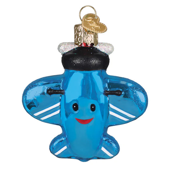 Blue airplane-shaped ornament with a smiley face on a white background