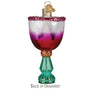 Decorative glass ornament resembling a cocktail glass with a colorful gradient and glittery accents on a white background.