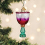 Decorative glass ornament with a colorful design hanging on a Christmas tree.