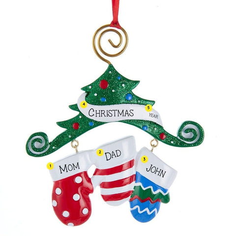 Personalized ornament with three colorful mittens hanging beneath a glittered Christmas tree, with space for three names, a holiday word or family name and the year.