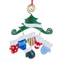 Colorful Christmas-themed ornament with mittens and a tree on a white background