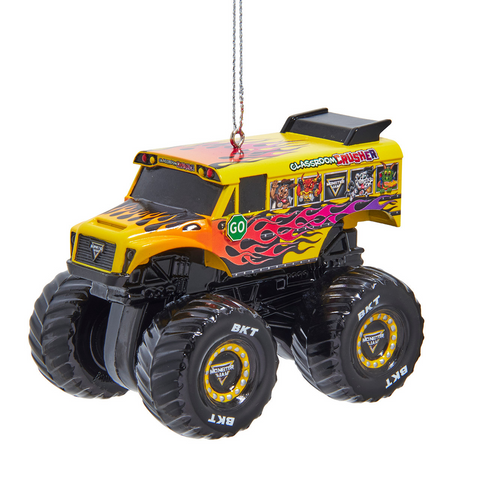 Monster Jam Classroom Crusher ornament featuring a yellow and orange monster truck with flame graphics, bus styling, and oversized black tires.