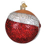 Decorative Christmas ornament with red glittery base and white top on a white background