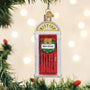 Christmas ornament resembling a red door with 'New Home' sign, hanging on a decorated tree.
