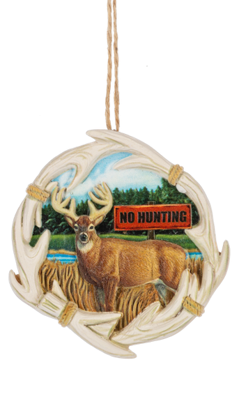 No Hunting Deer ornament featuring a brown buck standing in a nature scene with trees, water, and tall grass, framed by a ring of antlers and a rustic “No Hunting” sign.