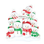 Snowman family tabletop decoration for 9 featuring nine smiling snowmen around a North Pole sign, with red and green hats and scarves on a white snowy base.
