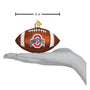 Glass football ornament with Ohio State logo on a white background