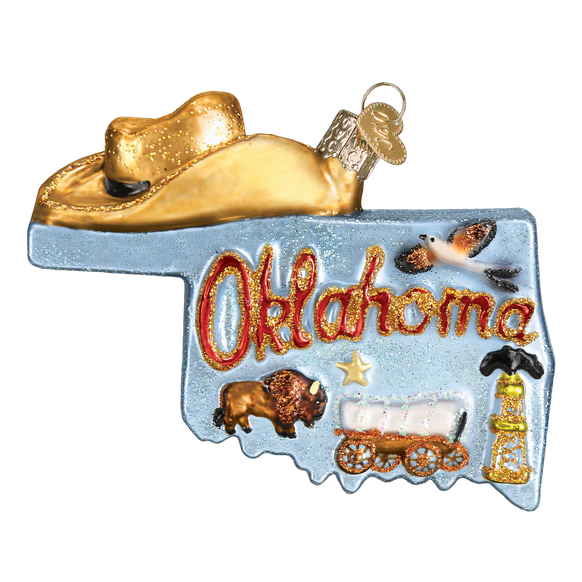Decorative ornament shaped like the state of Oklahoma with a cowboy hat, cow, buffalo, and oil derrick.