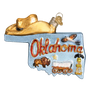 Decorative ornament shaped like the state of Oklahoma with a cowboy hat, cow, buffalo, and oil derrick.