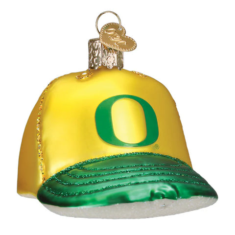 Glass ornament shaped like a yellow and green Oregon Ducks cap with a large 'O'.
