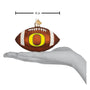 Decorative football ornament with 'O' Oregon Ducks logo on a white background, shown with a hand for scale.