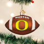 Football-shaped ornament with 'O' Oregon Ducks logo hanging on a Christmas tree