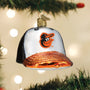 Glass ornament shaped like a baseball cap with Orioles logo, hanging on a Christmas tree.