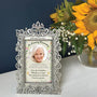 Always Loved Forever Missed floral memorial card frame displayed on a tabletop beside a vase of bright yellow sunflowers.