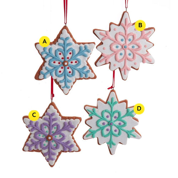 Four pastel cookie ornaments in star and snowflake shapes with white icing and blue, pink, purple, and mint decorative details.