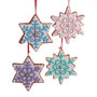 Four star-shaped gingerbread ornaments with colorful snowflake designs on a white background.