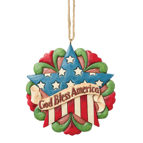 Front view of Jim Shore Patriotic Star Ornament featuring a red, white, and blue star with the message God Bless America.