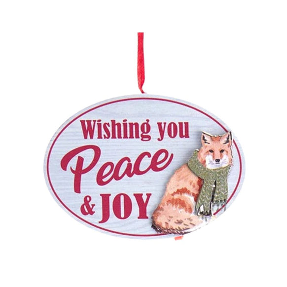 Oval ornament with the words “Wishing You Peace & Joy” and an illustrated fox wearing a green scarf on a white wood-look background.