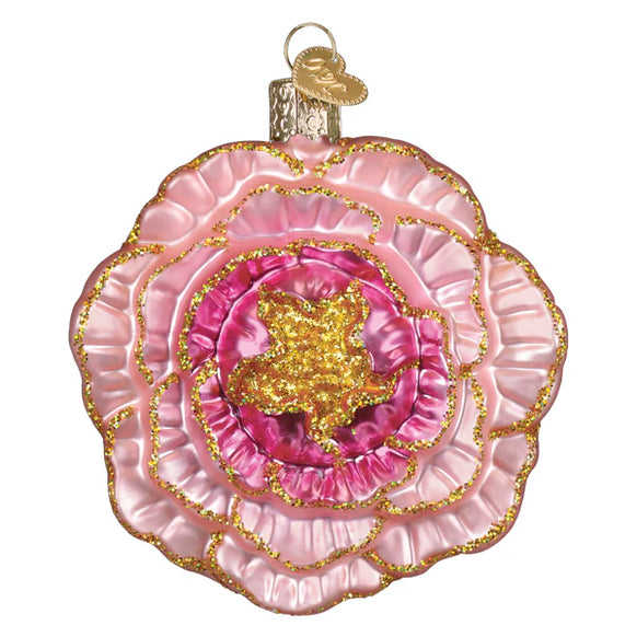 Decorative pink and gold Peony shaped ornament on a white background