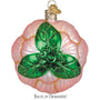 Decorative ornament with green floral design on a pink shell-like background